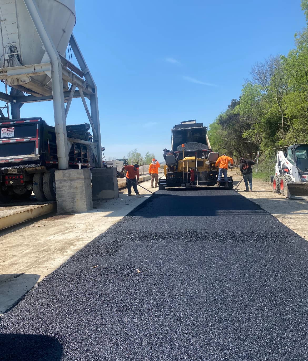 Original Asphalt crew laying hot mix on a paving job