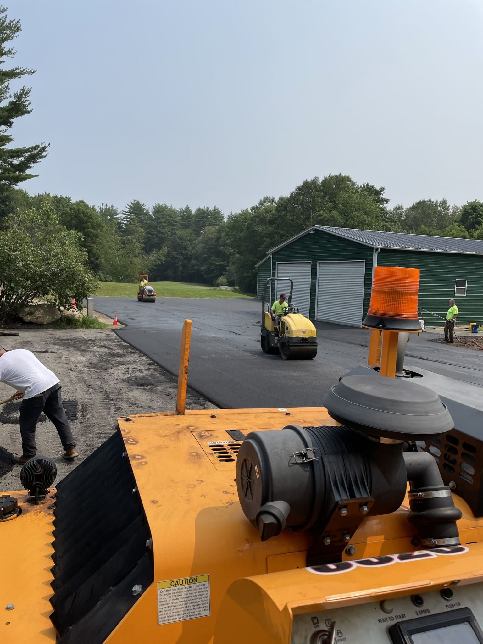 Original Asphalt crew operating paver equipment