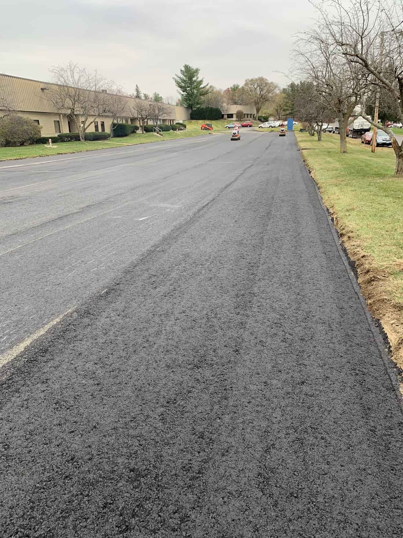 Asphalt resurfacing with rollers on a commercial road